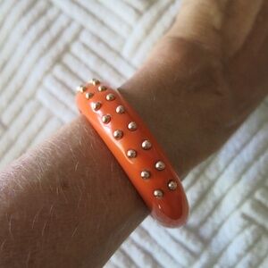 Kenneth Jay Lane vintage orange/coral lucite bangle with gold-colored studs